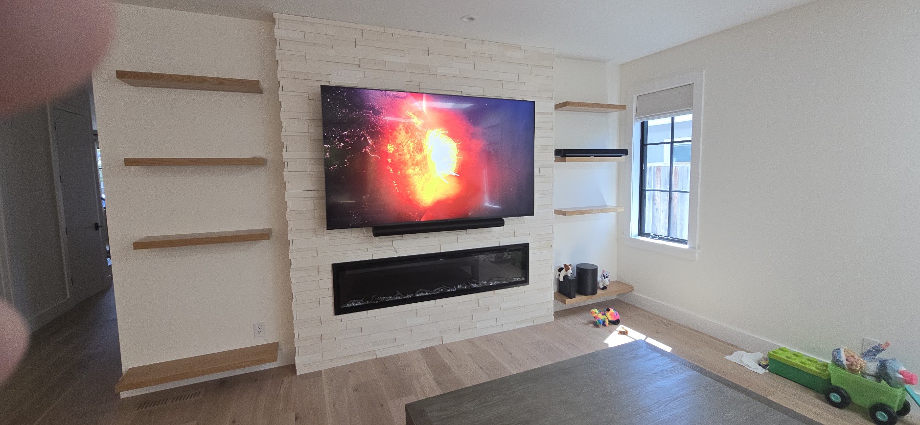 TV and fireplace with shelving