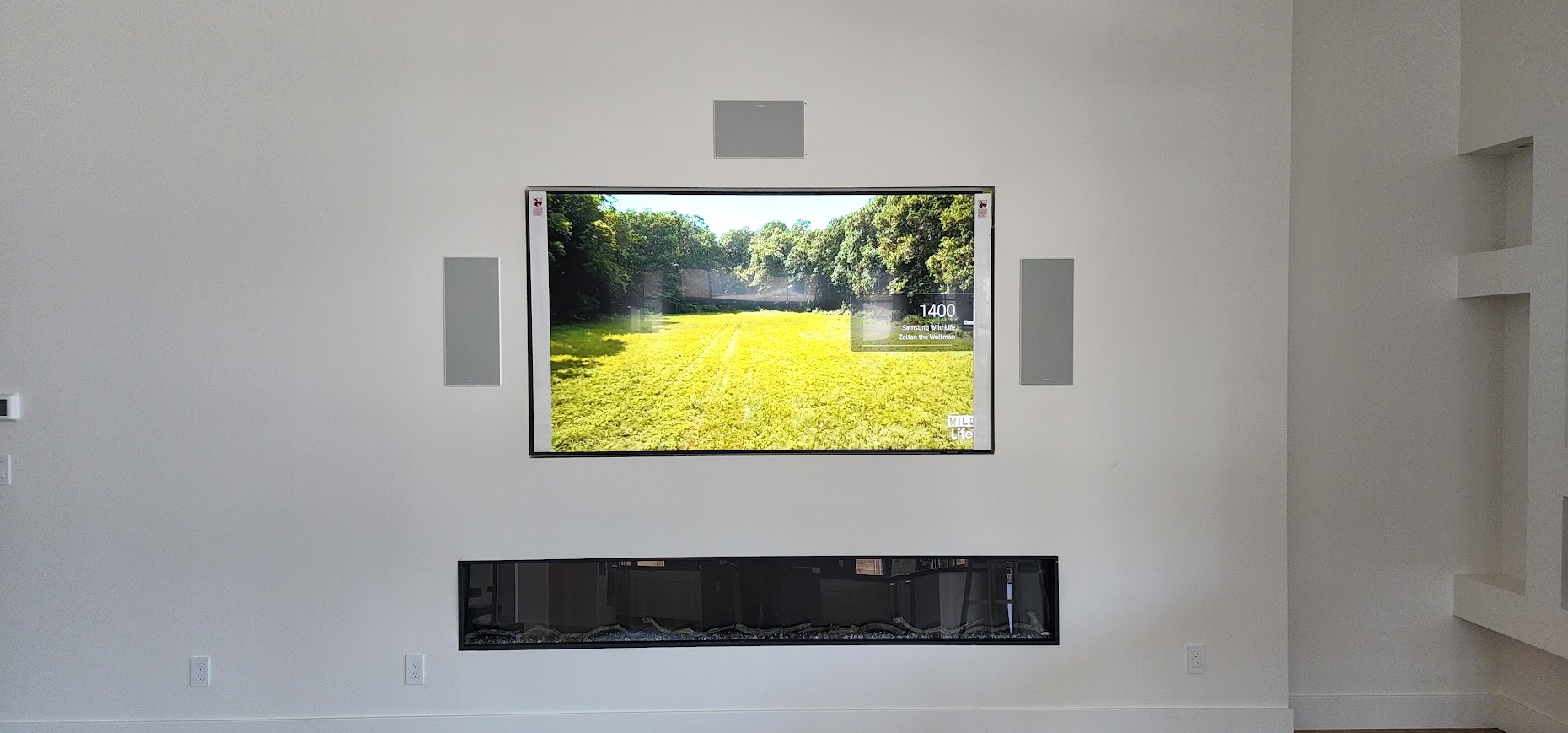 TV with integrated wall speakers